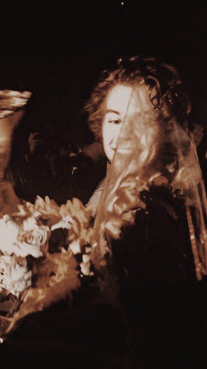 A woman with a bouquet of flowers. - Harry Styles