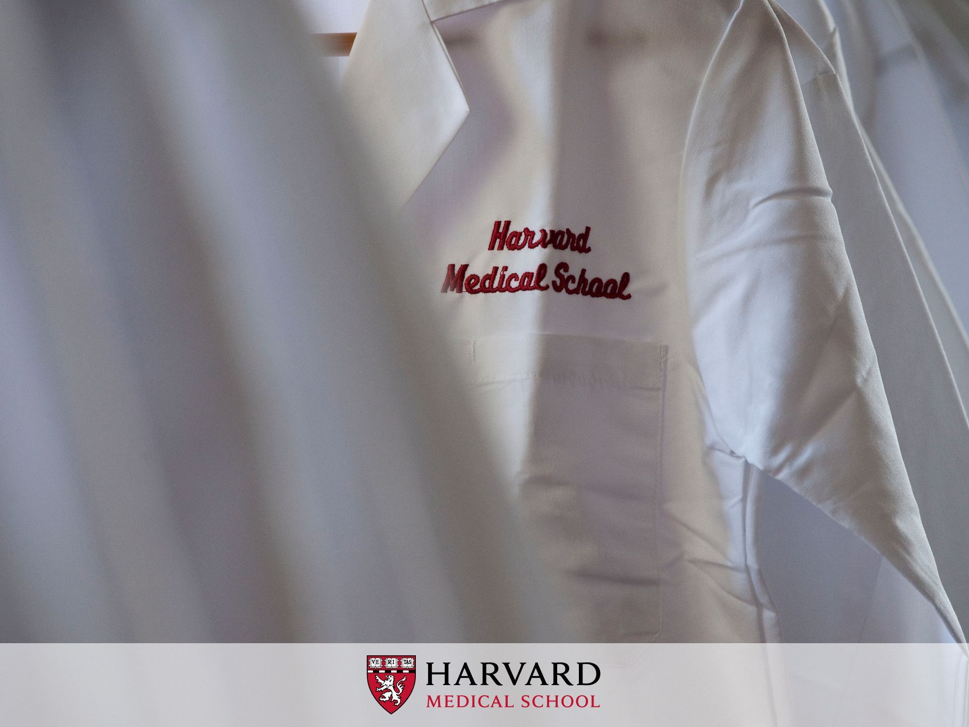 A white coat with Harvard Medical School embroidered on the pocket. - Harvard