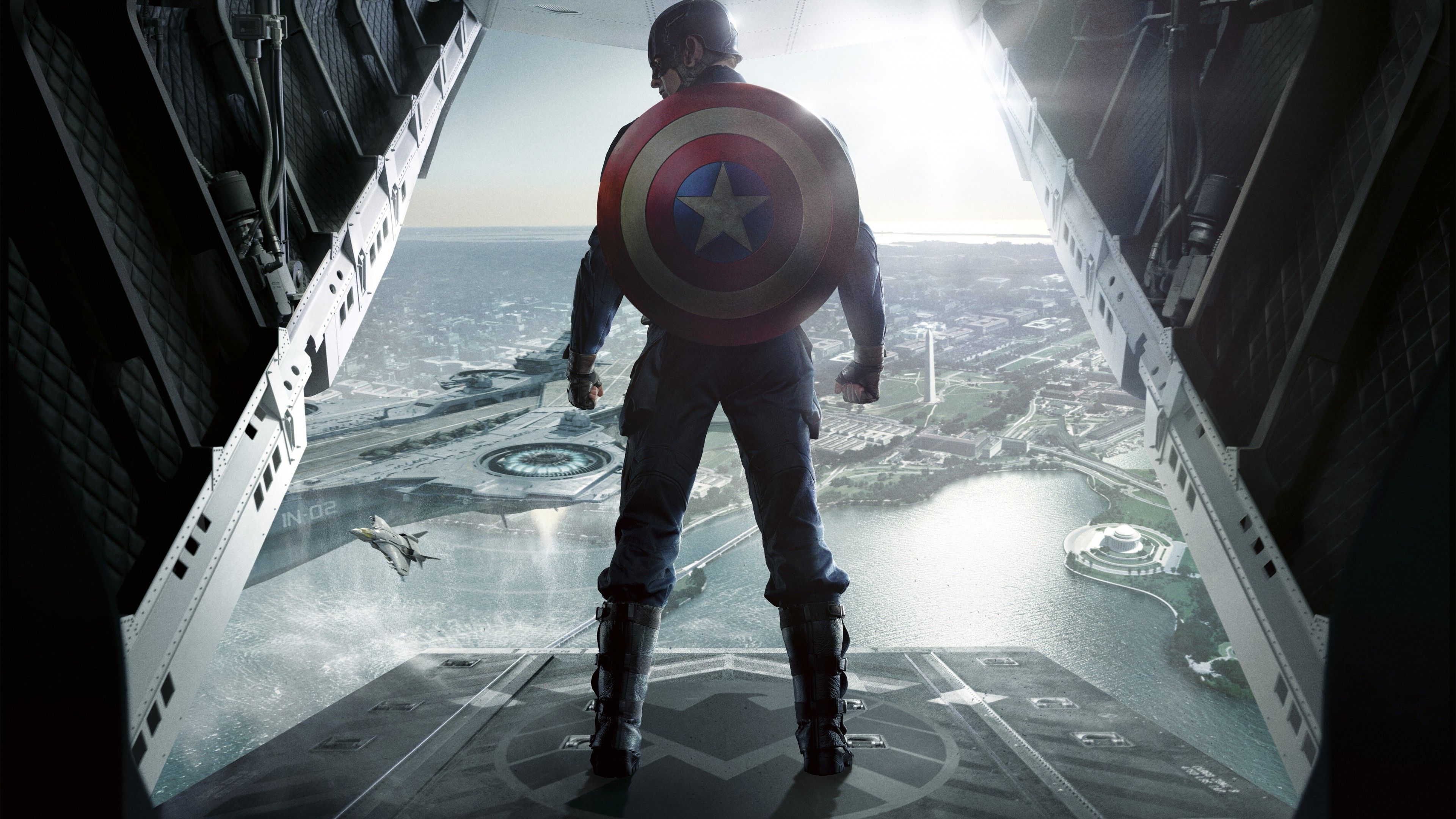 Captain America stands on a building looking out at the city - Captain America