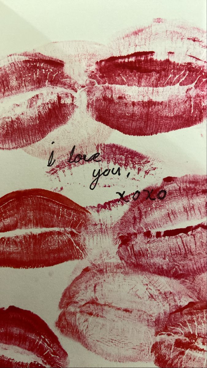 A piece of paper with red lipstick marks on it, with the words 