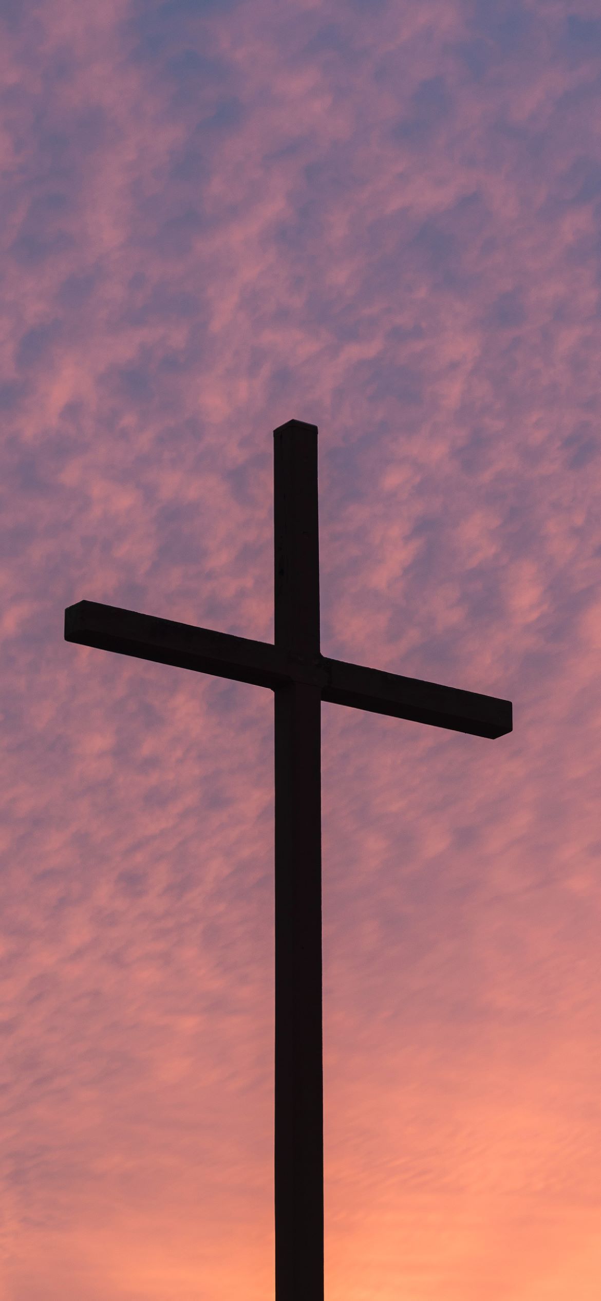 A cross silhouette in front of a pink and purple sunset sky. - Cross, christian iPhone
