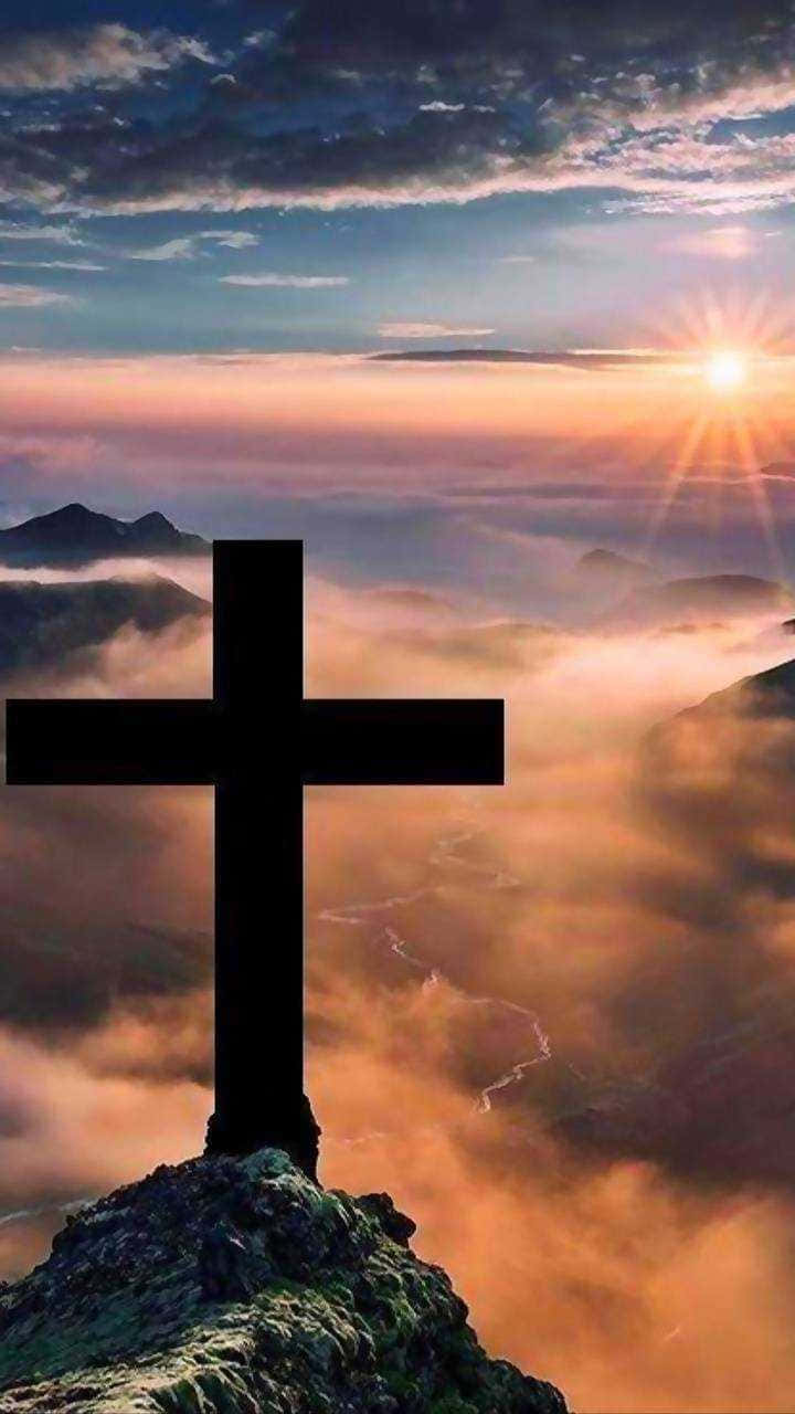 Cross on a mountain with the sun rising behind it - Cross, balance