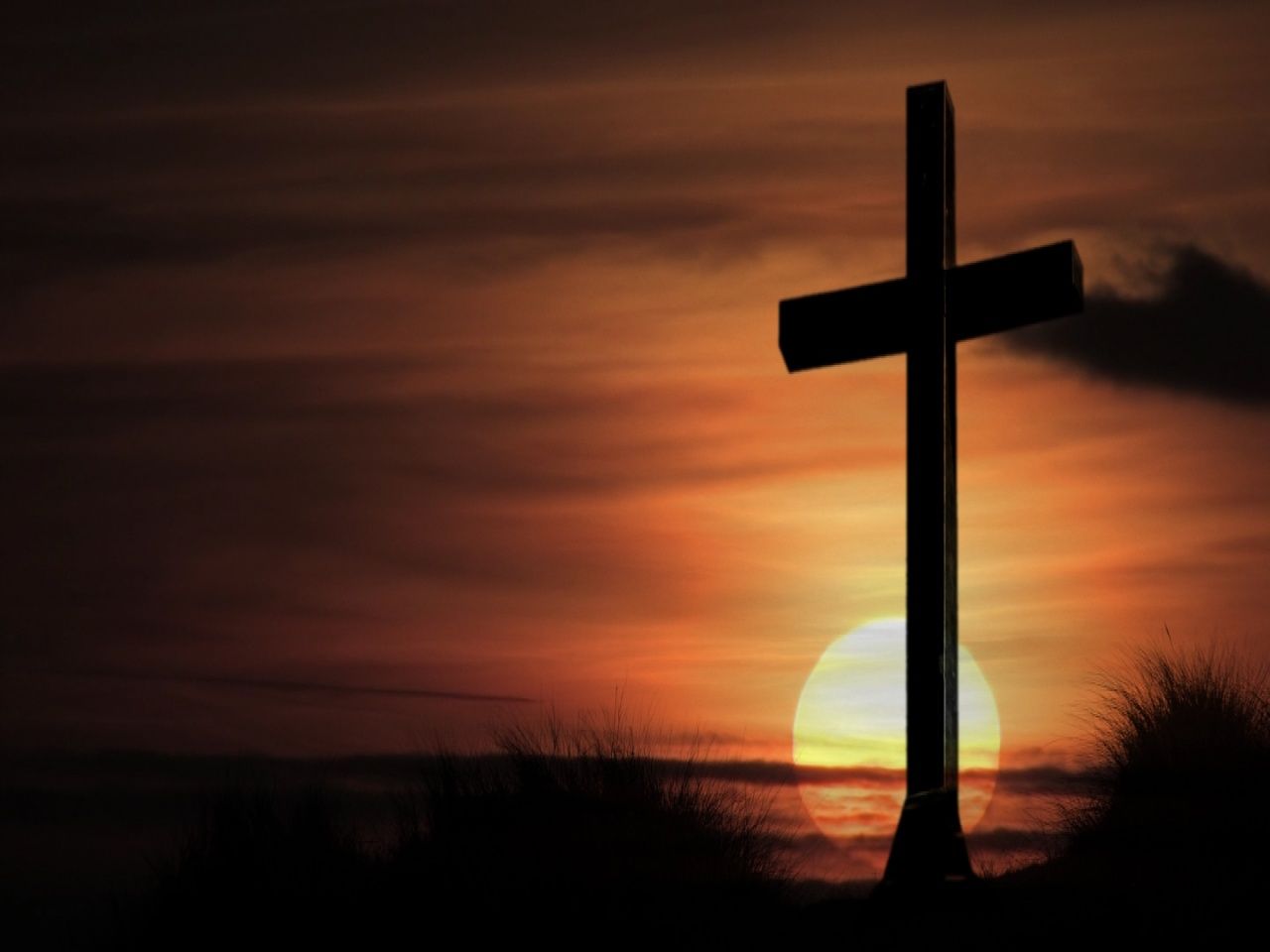 Cross in front of a sunset - Cross