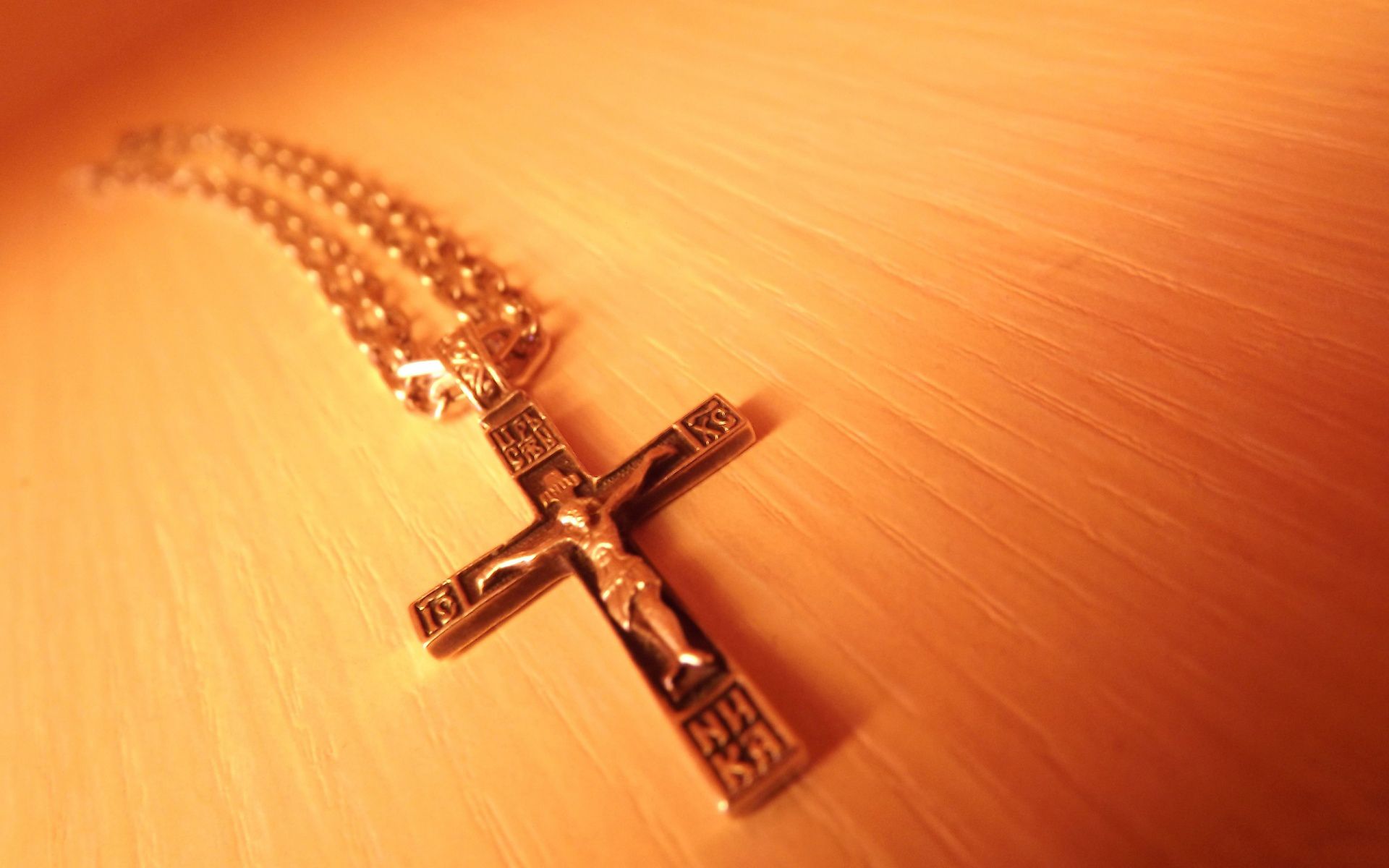 A gold crucifix necklace with Jesus on it - Cross