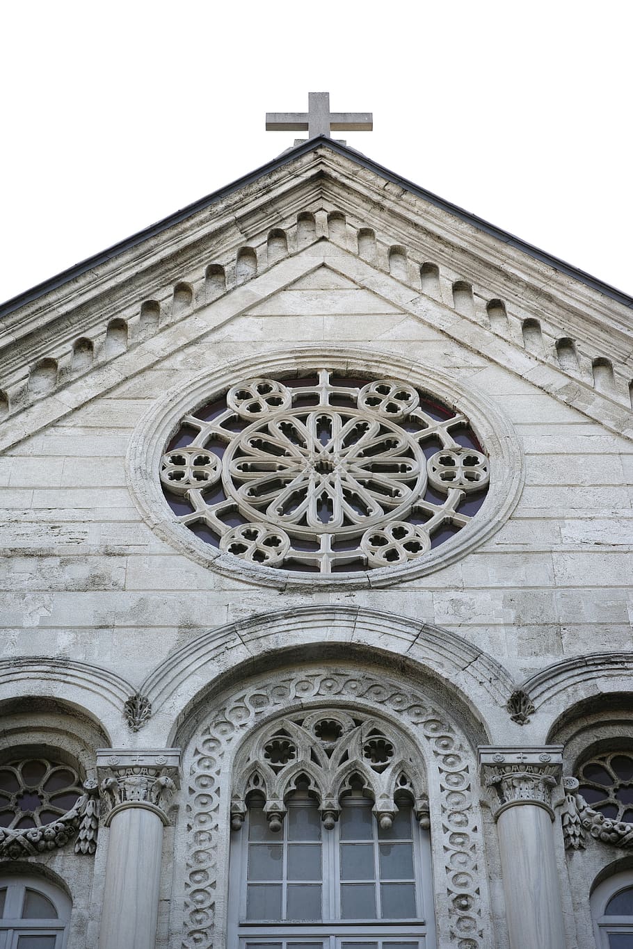 The facade of the church of San Giovanni Battista in Savona, Italy, features a rose window and a cross. - Cross