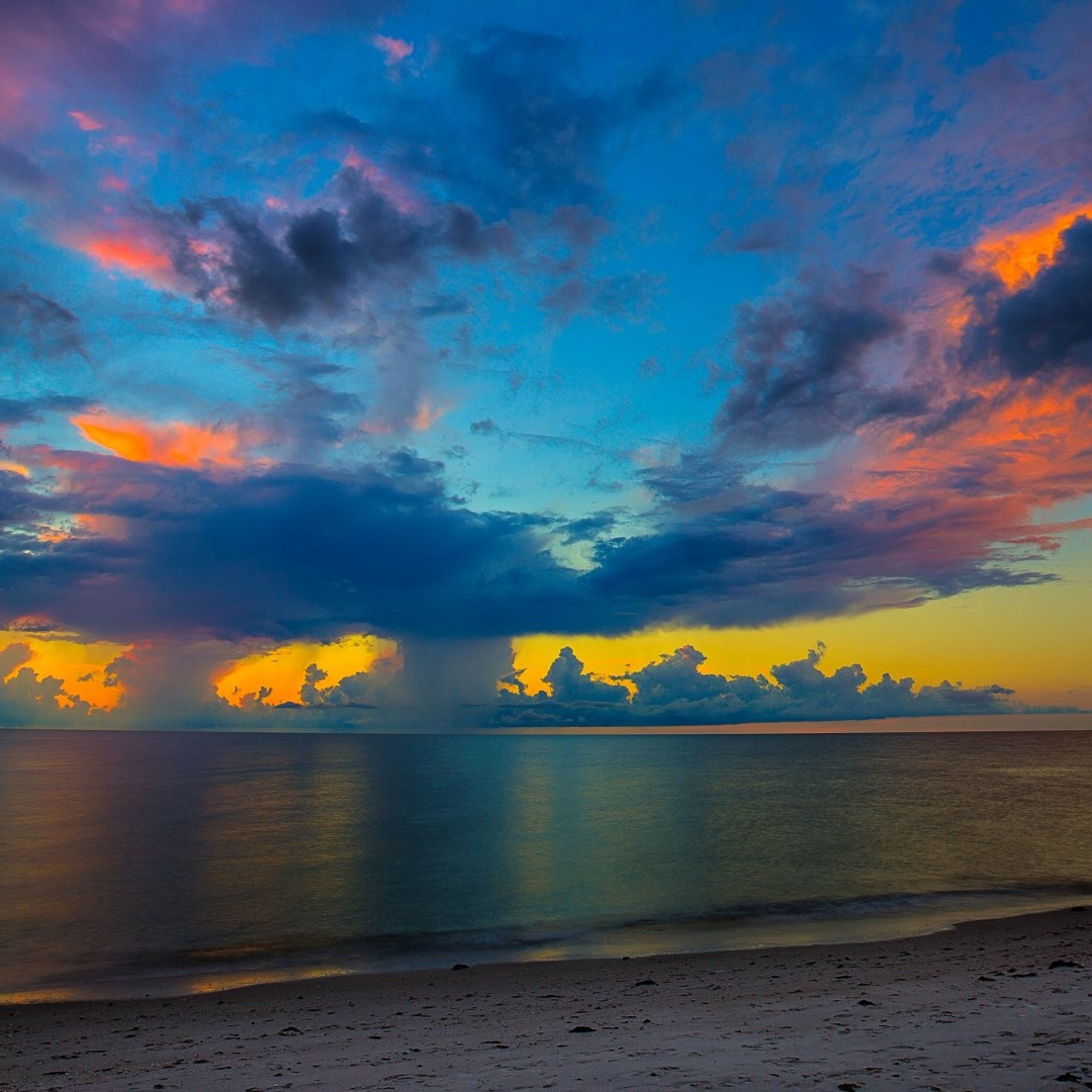 A beautiful sunset with clouds reflecting in the ocean - Florida
