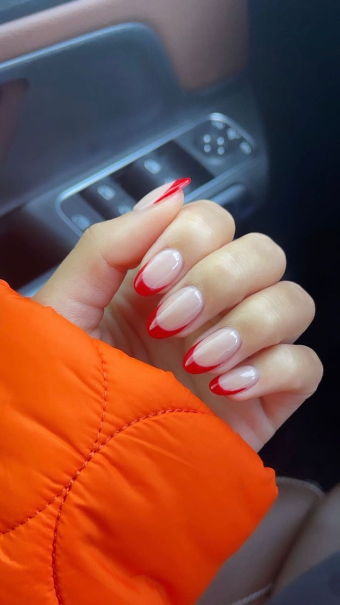 A woman's hand with red and white french tip nails. - Nails