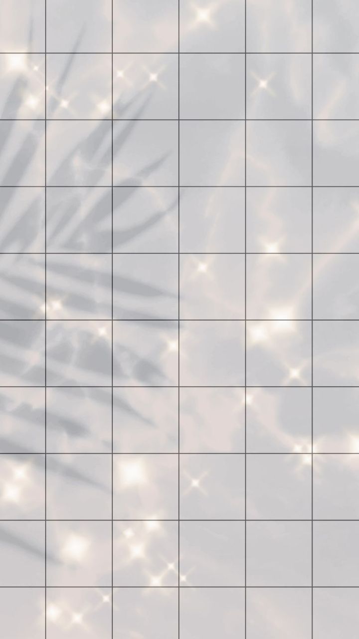 Aesthetic background of a grid of white tiles with a palm leaf shadow and lens flares. - Bling