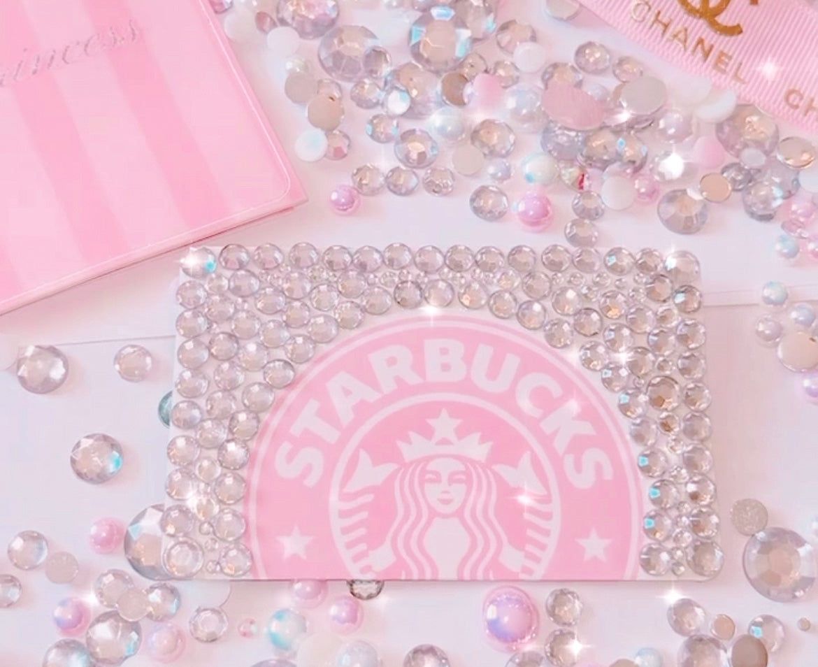 A Starbucks card with a pink background and white lettering. - Bling