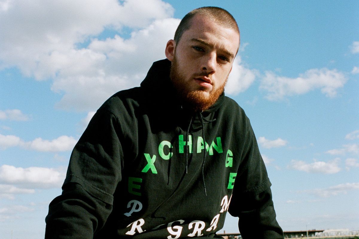 Mac Miller wearing a black hoodie with the words 