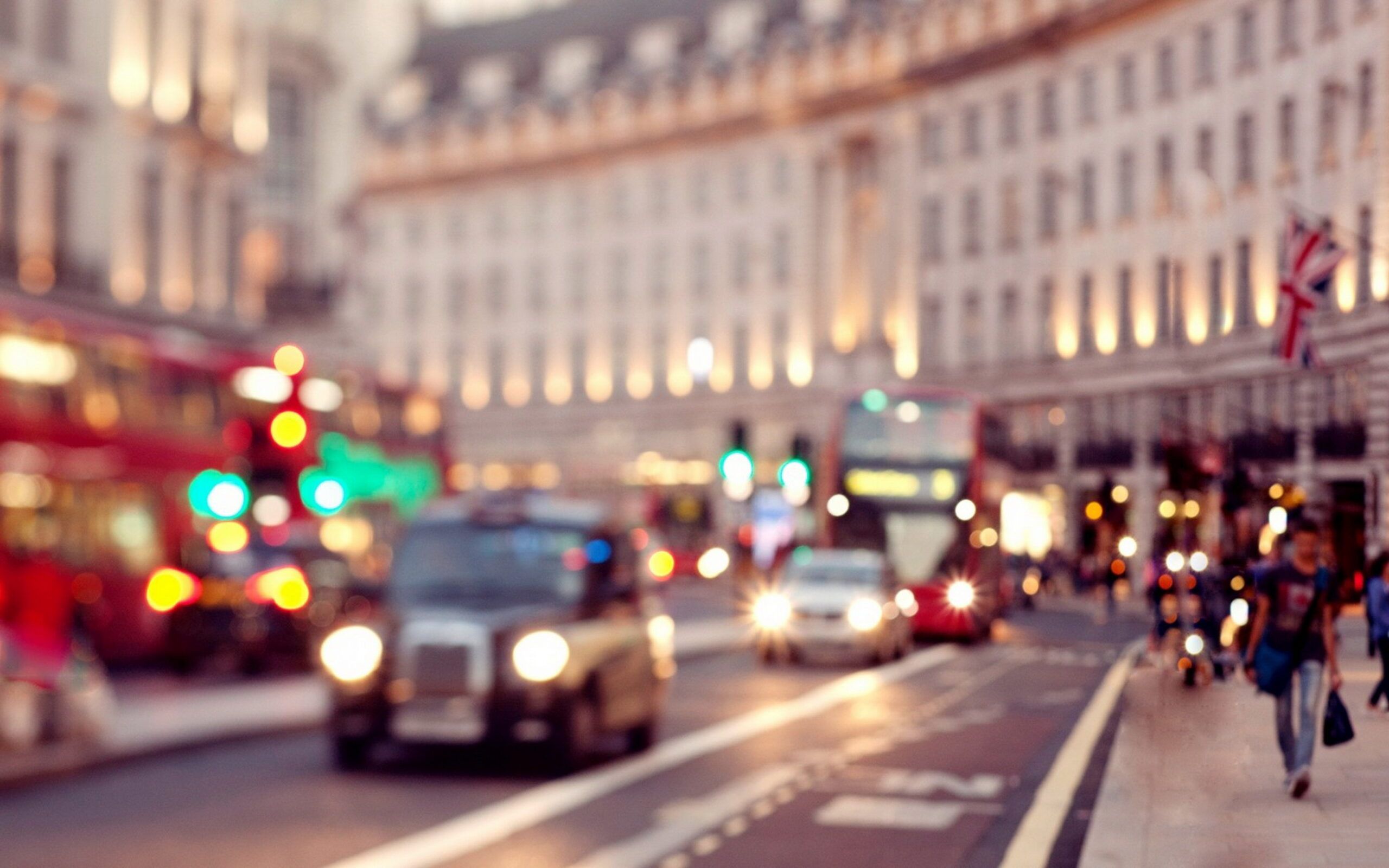 A busy city street with cars, buses, and pedestrians. - London