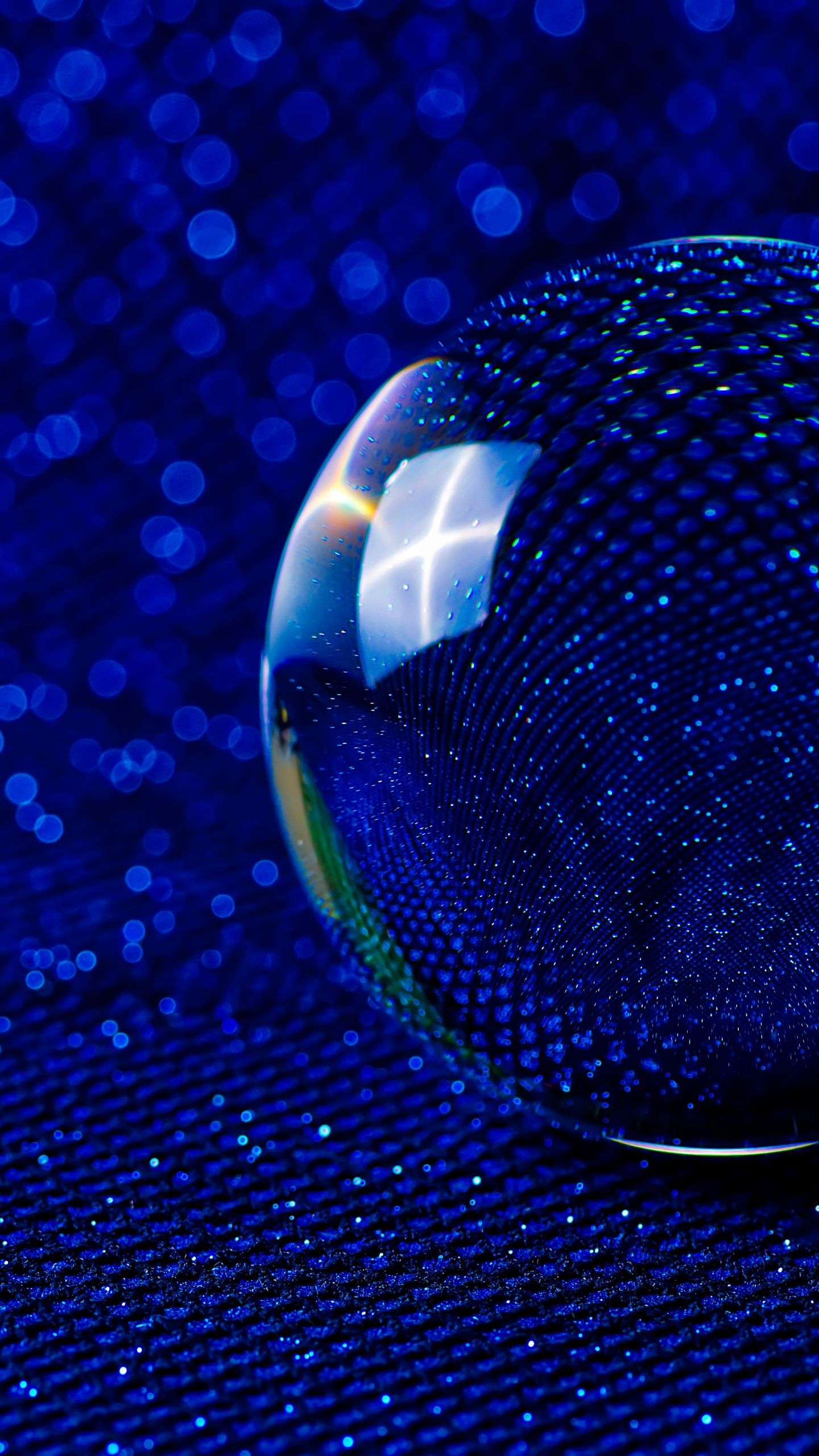 A crystal ball on a blue background with bokeh effect. - Dark blue