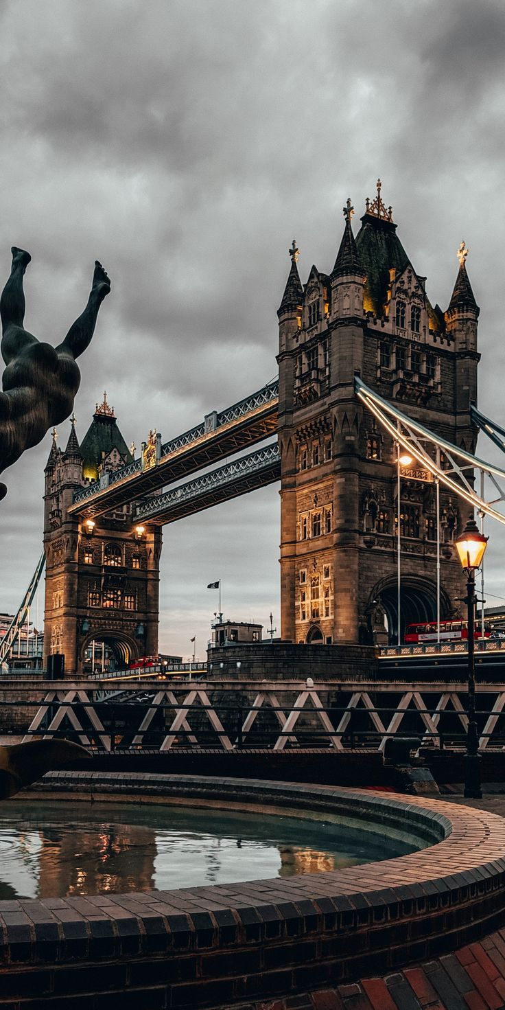 A statue of two people in front - London