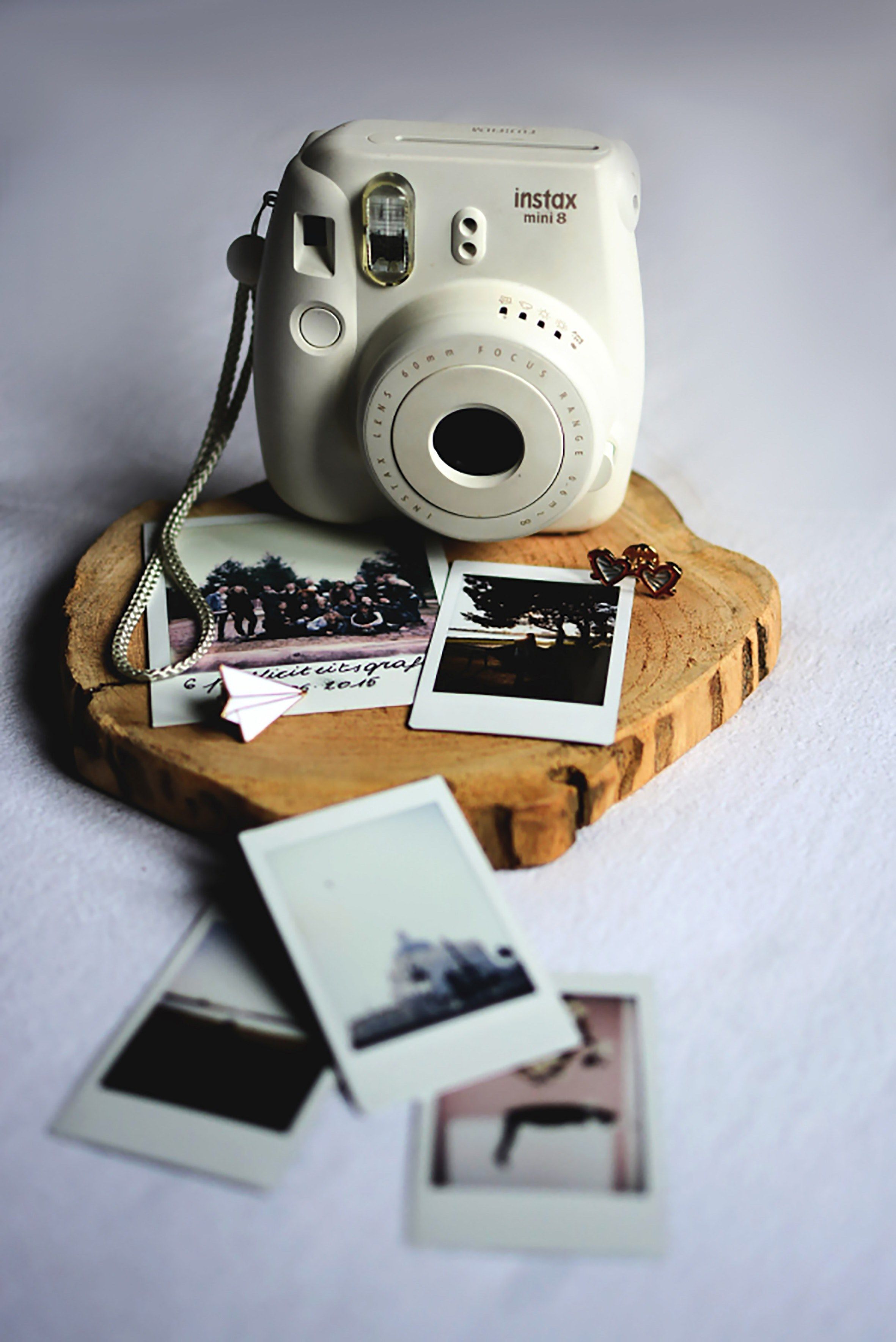 A polaroid camera sitting on top of some pictures - Polaroid