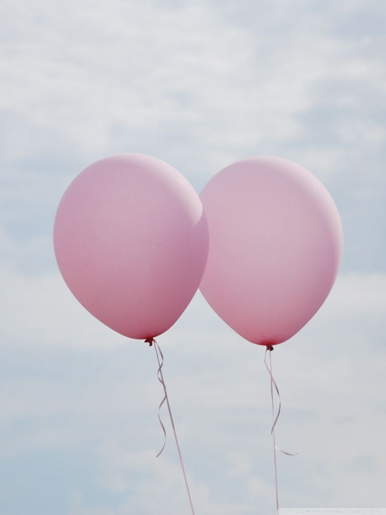 Two pink balloons floating in the sky - Balloons