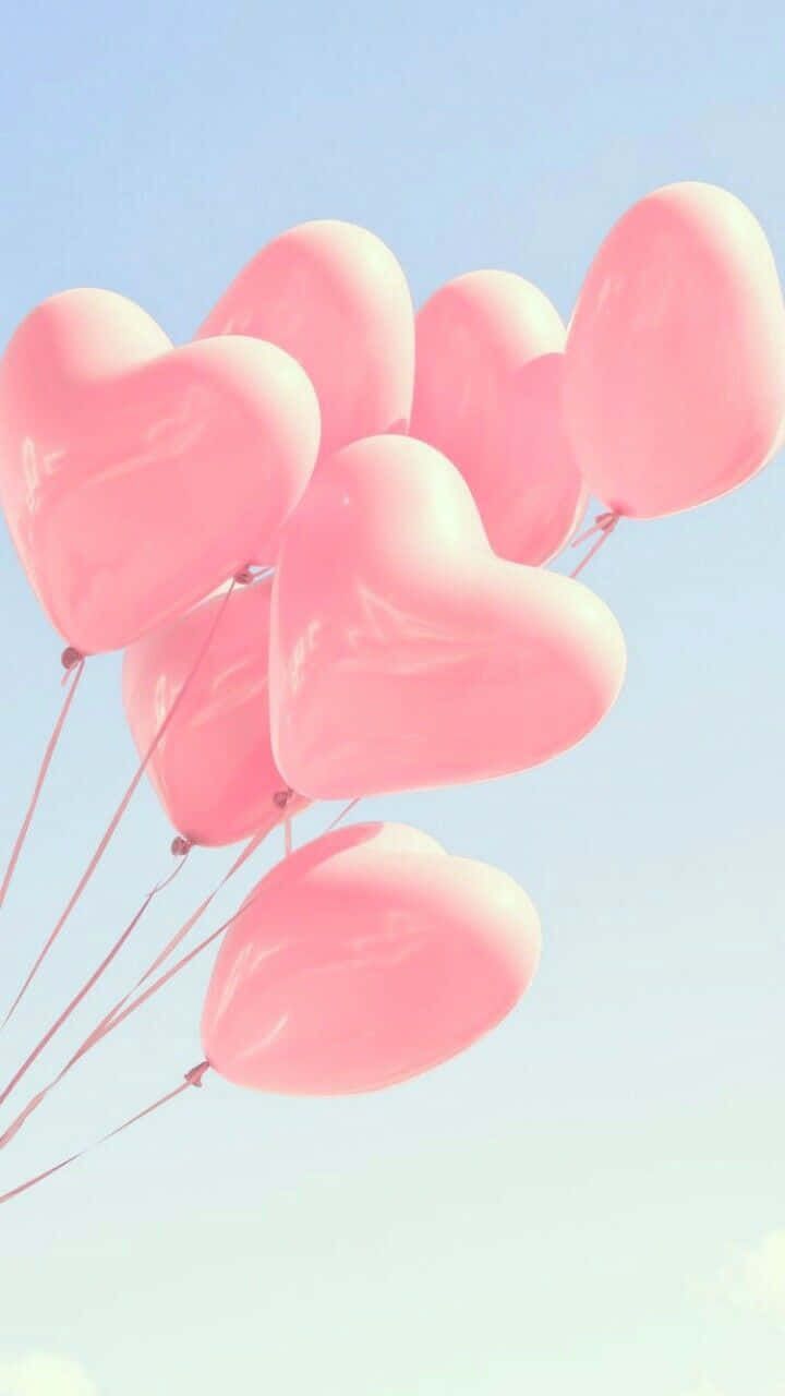 Pink heart balloons floating in the sky - Balloons