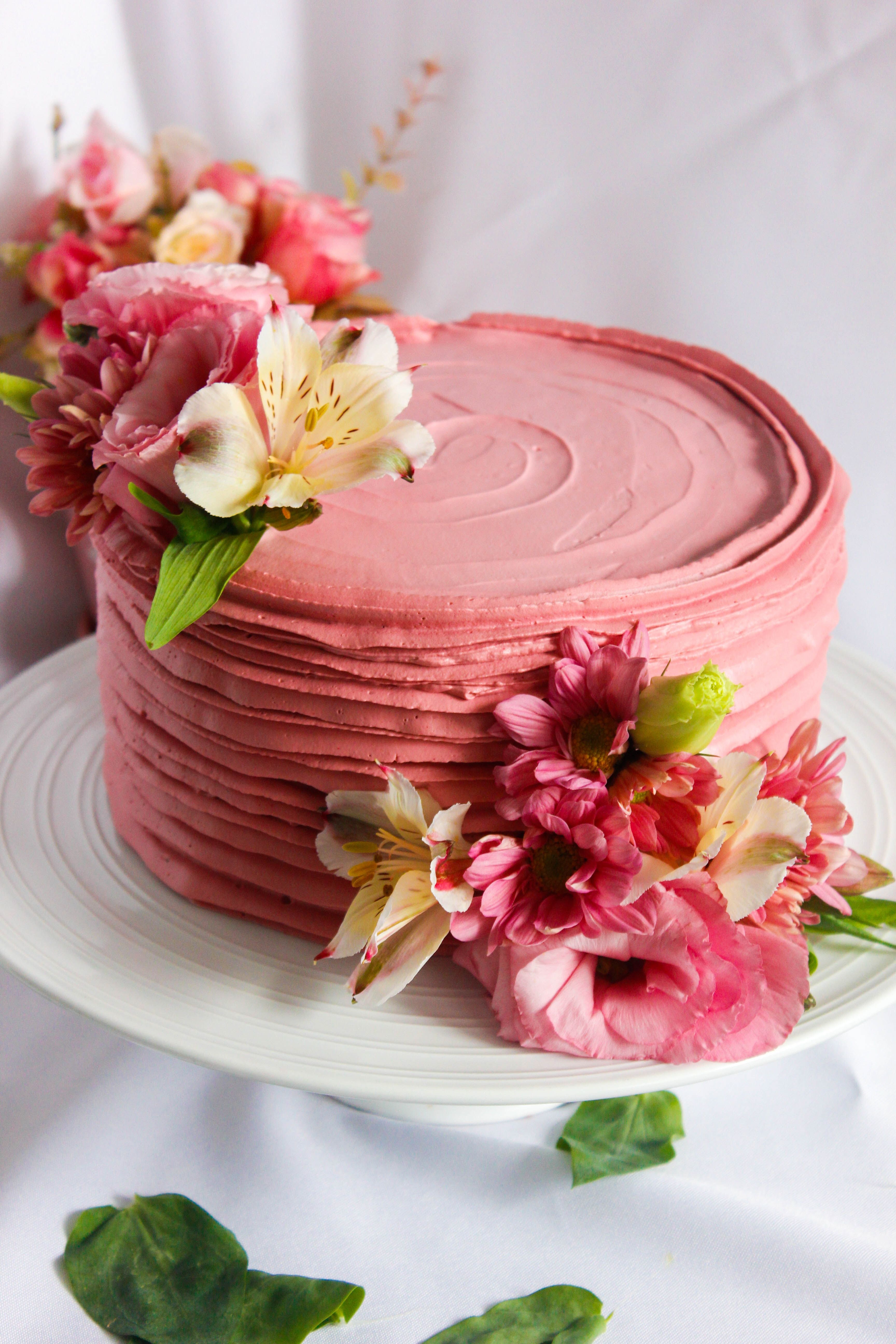 A pink cake with flowers on top - Cake