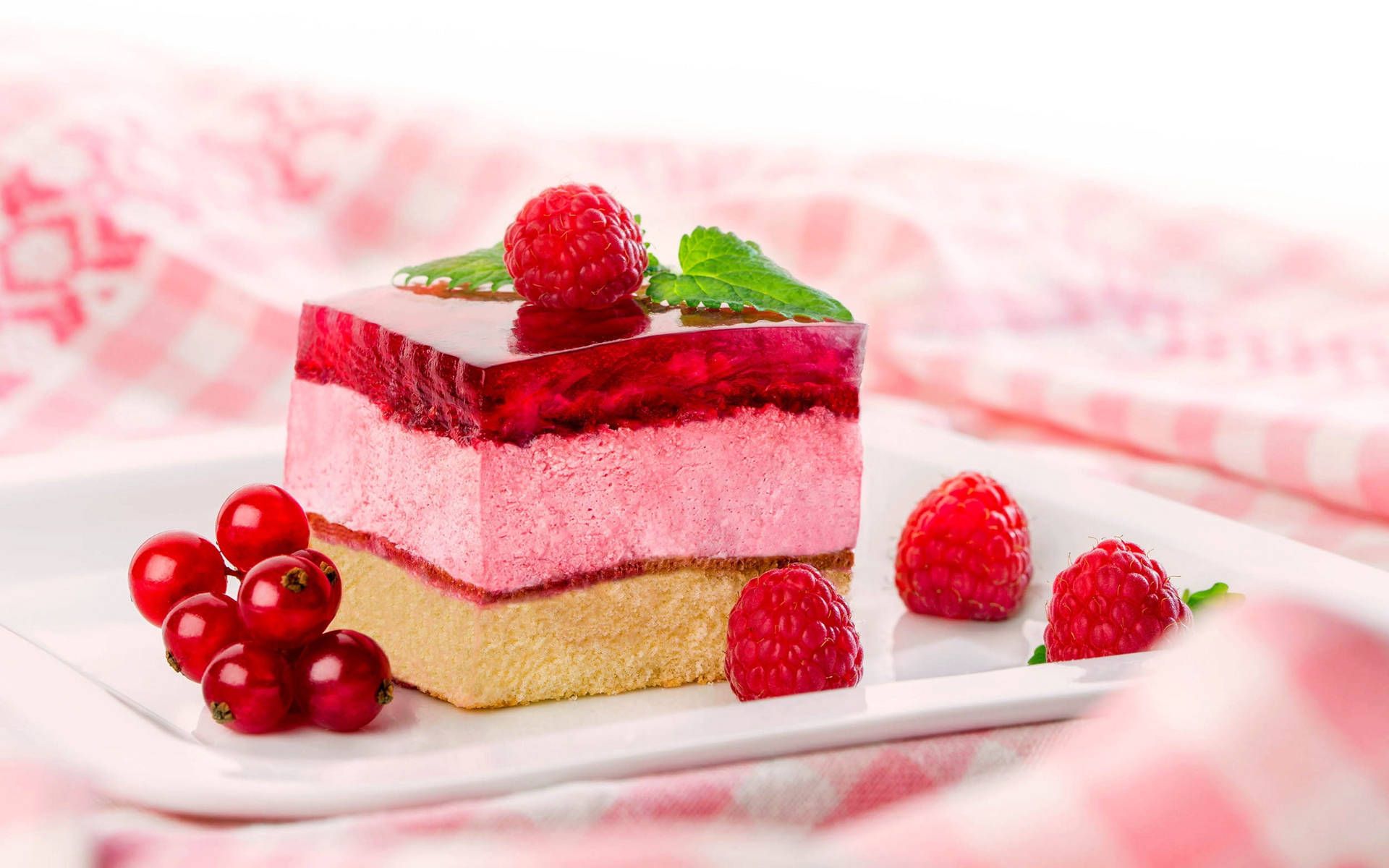 A piece of cake with red fruits on a plate - Cake