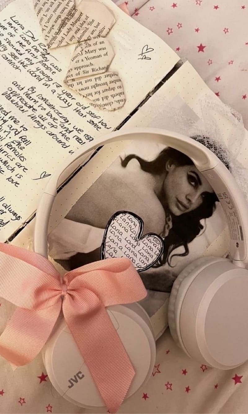A photo of Ariana Grande is seen on the inside of a pair of white headphones. - Coquette