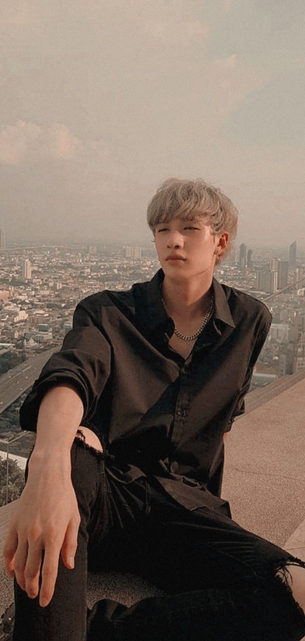 A man sitting on the edge of something - Bang Chan