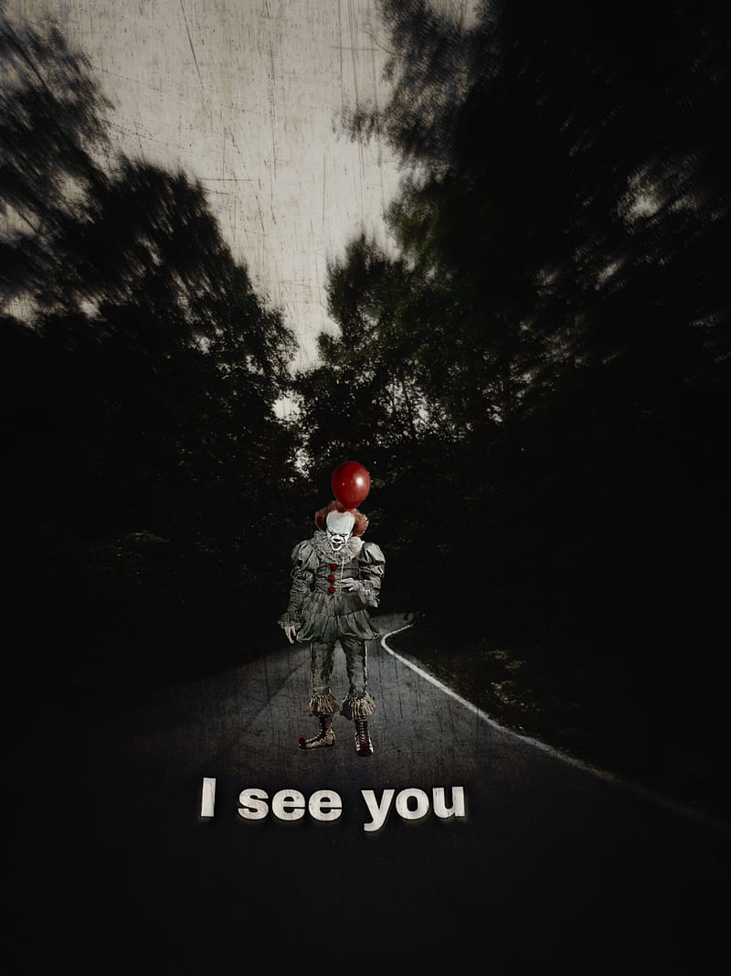 A creepy clown holding a red balloon - Pennywise