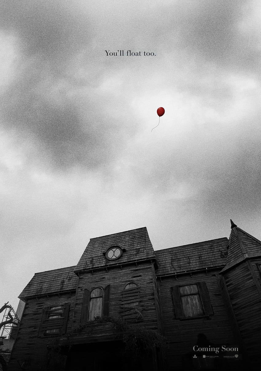 A red balloon floats above a house in the movie IT. - Pennywise