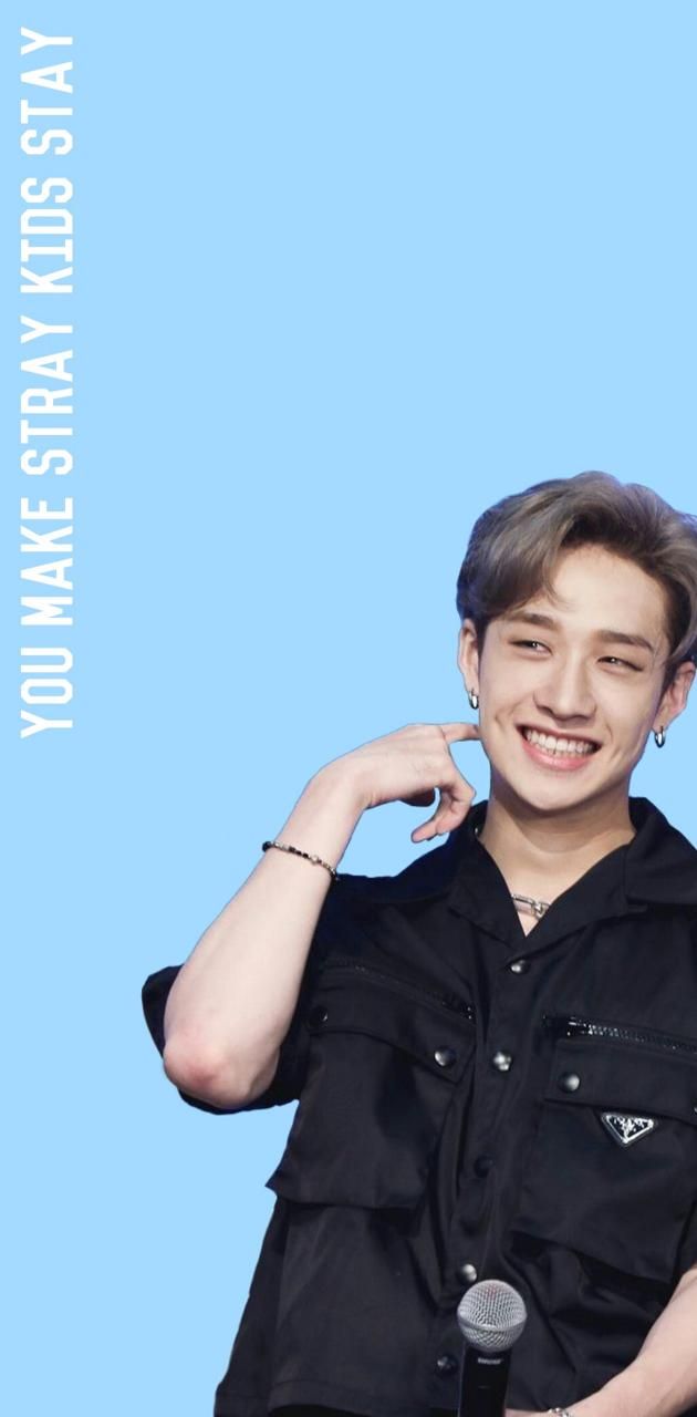 A man with black shirt and blue background - Bang Chan