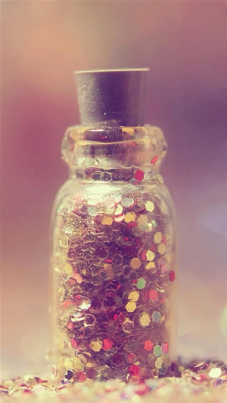 A small glass jar filled with glitter - Bling