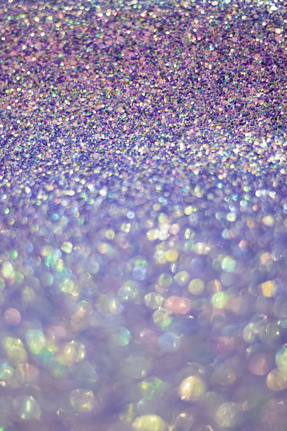 A close up of a pile of purple and blue glitter. - Bling, glitter