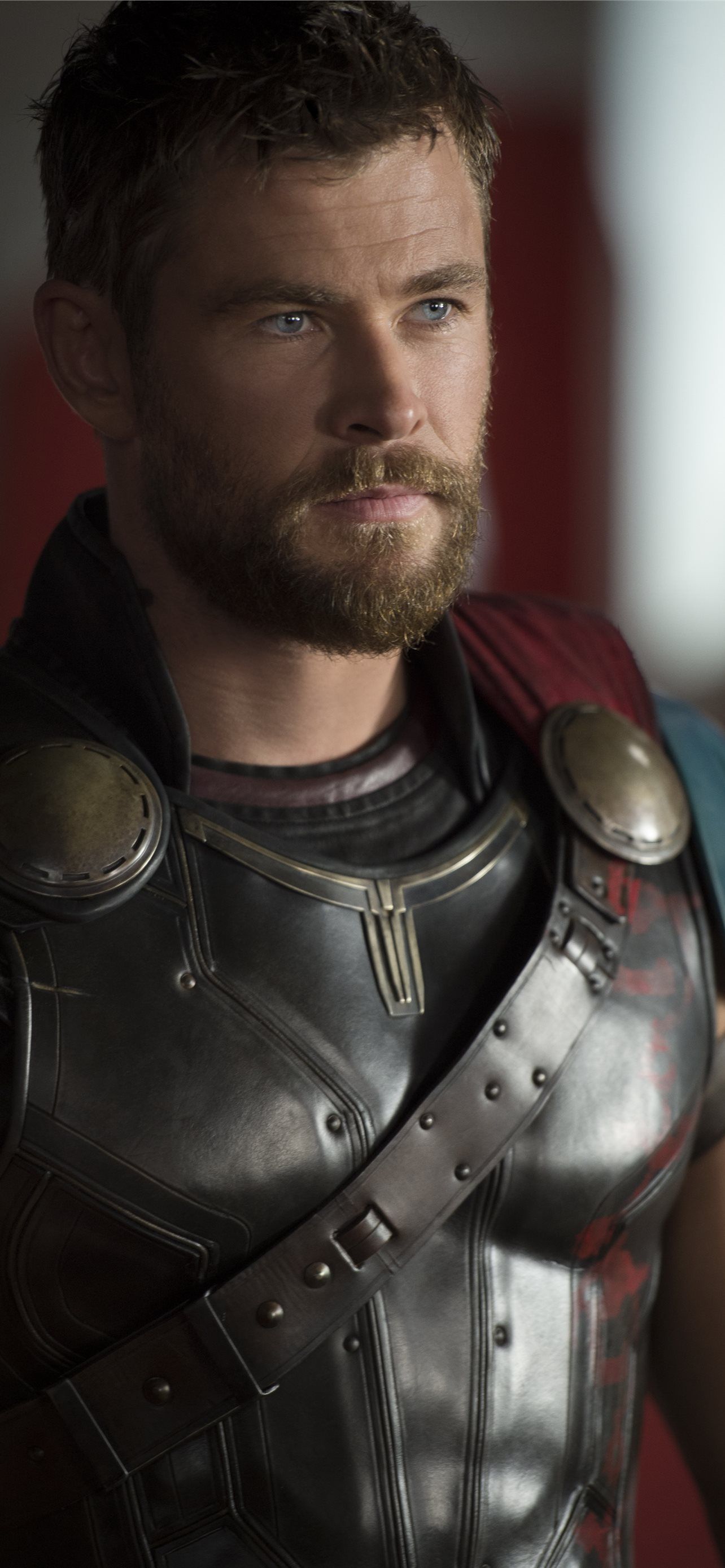 Chris Hemsworth as Thor in a armor suit, looking to the right of the camera. - Thor