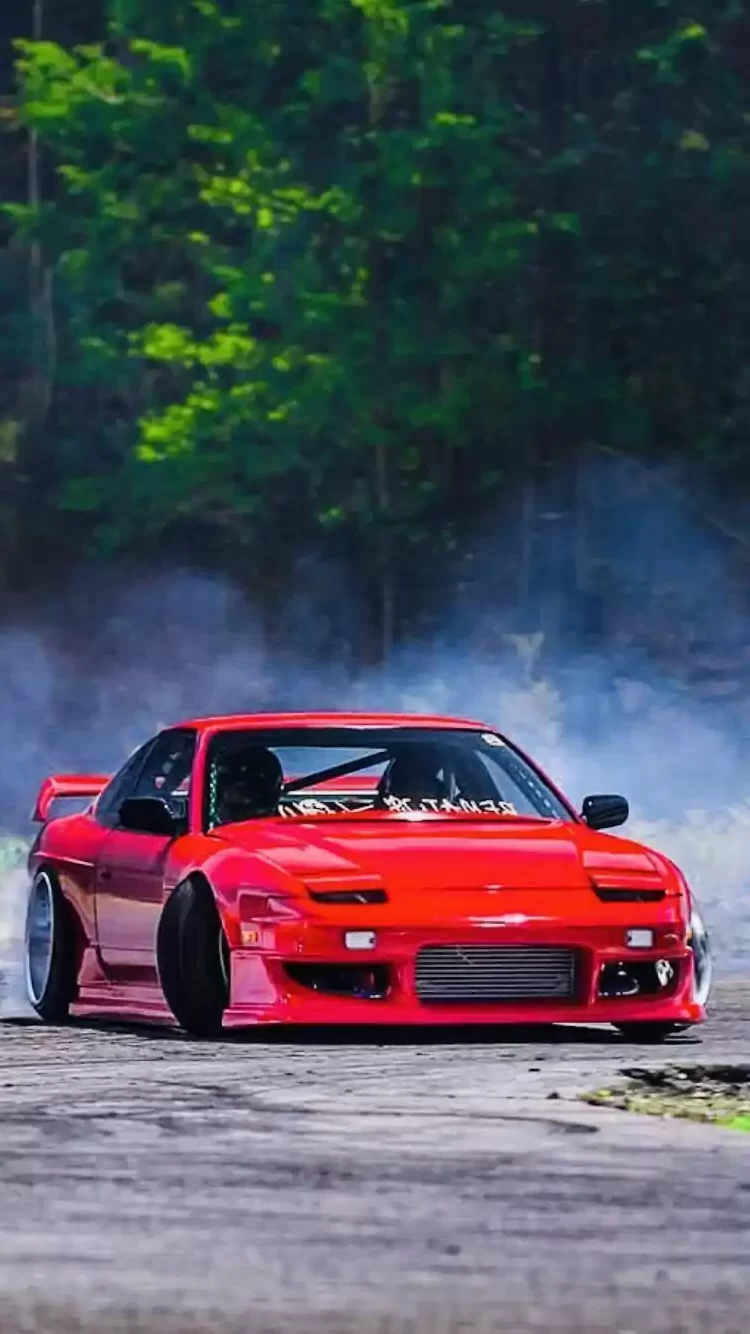 A red car is drifting on a road - JDM