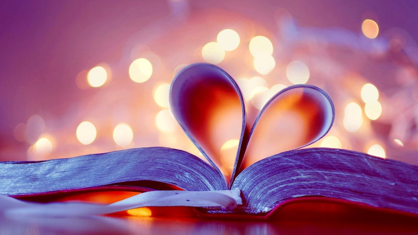 A book with hearts on it sitting in front of lights - Valentine's Day