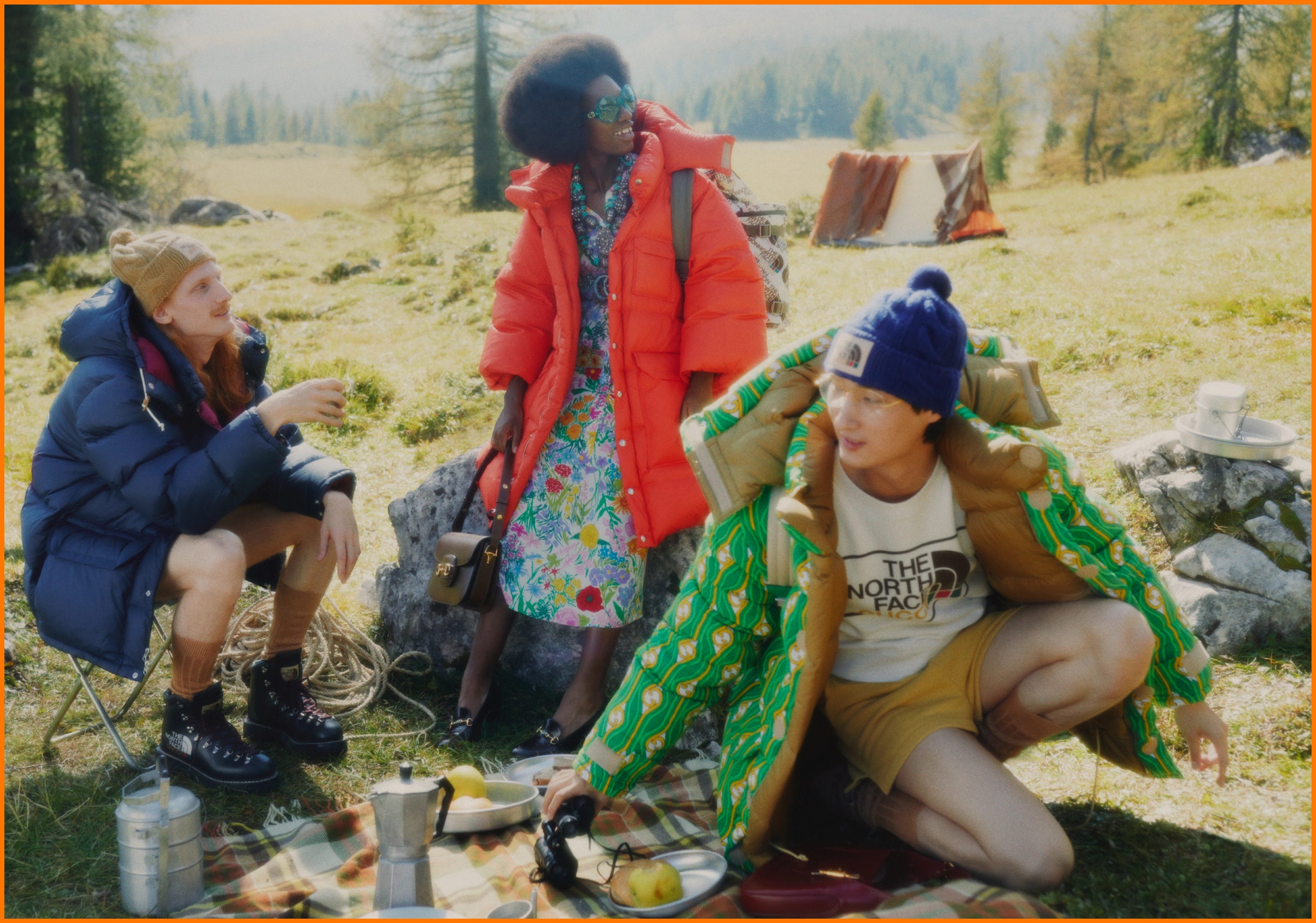 A group of friends wearing The North Face x Gucci collection having a picnic - Gorpcore