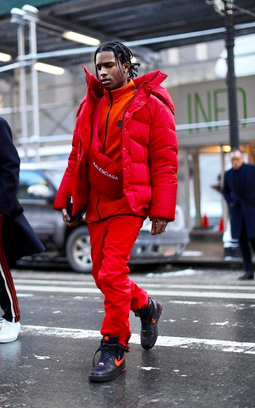 A man wearing a red jacket and matching red pants. - Gorpcore
