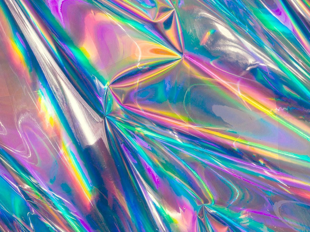 A crumpled piece of holographic plastic with rainbow colors. - Holographic