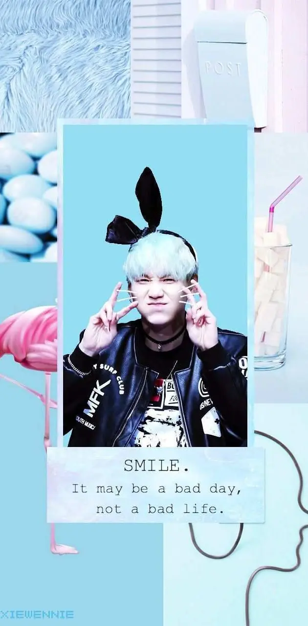 A photo of a boy with white hair and a blue background with a quote on it - Suga