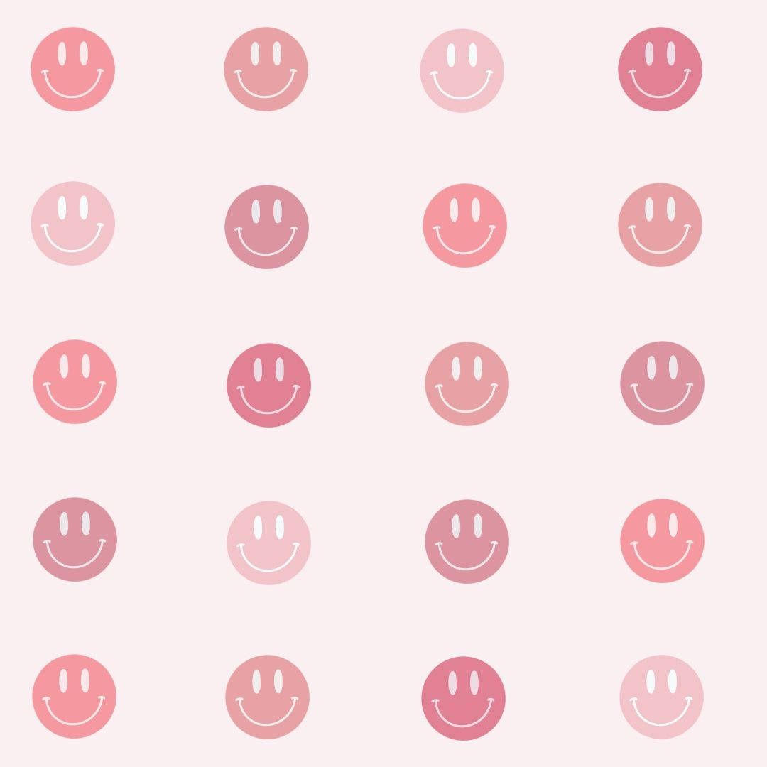 A pattern of pink and coral gradient smiley faces on a light pink background - Smiley