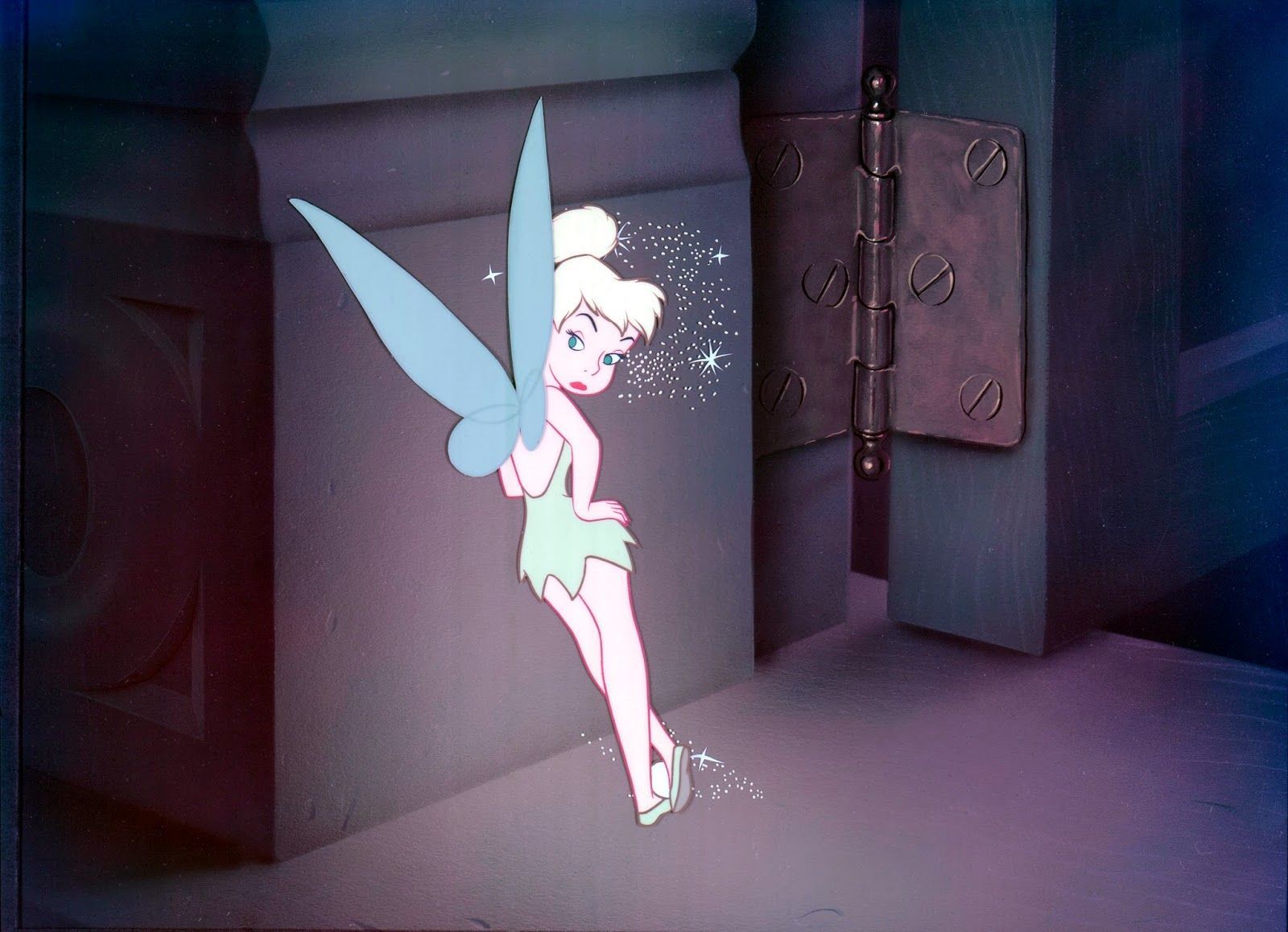 Tinker Bell, a fairy with light blue wings and a green dress, stands in a pink room with a green door. - Tinkerbell
