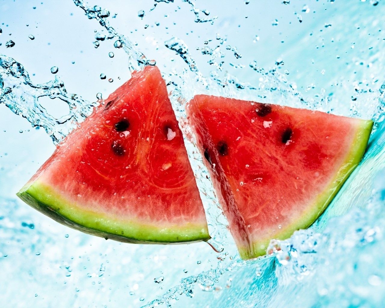 Two slices of watermelon are being splashed in water - Watermelon