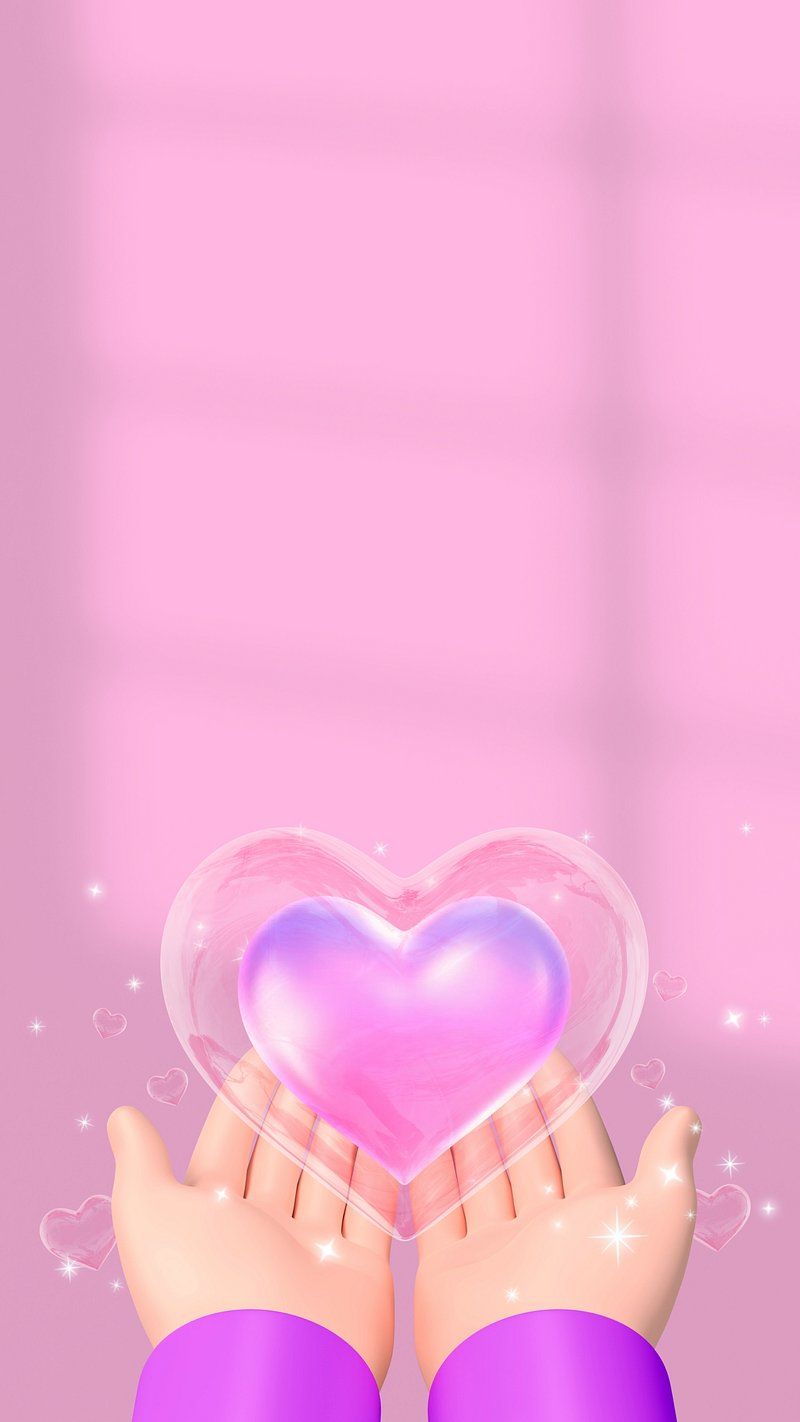Hands holding a pink heart on a pink background. - Pink heart