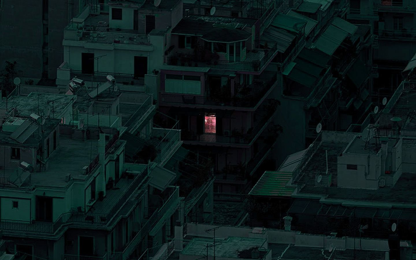 A pink door is lit up in the middle of a dark city. - Dark green