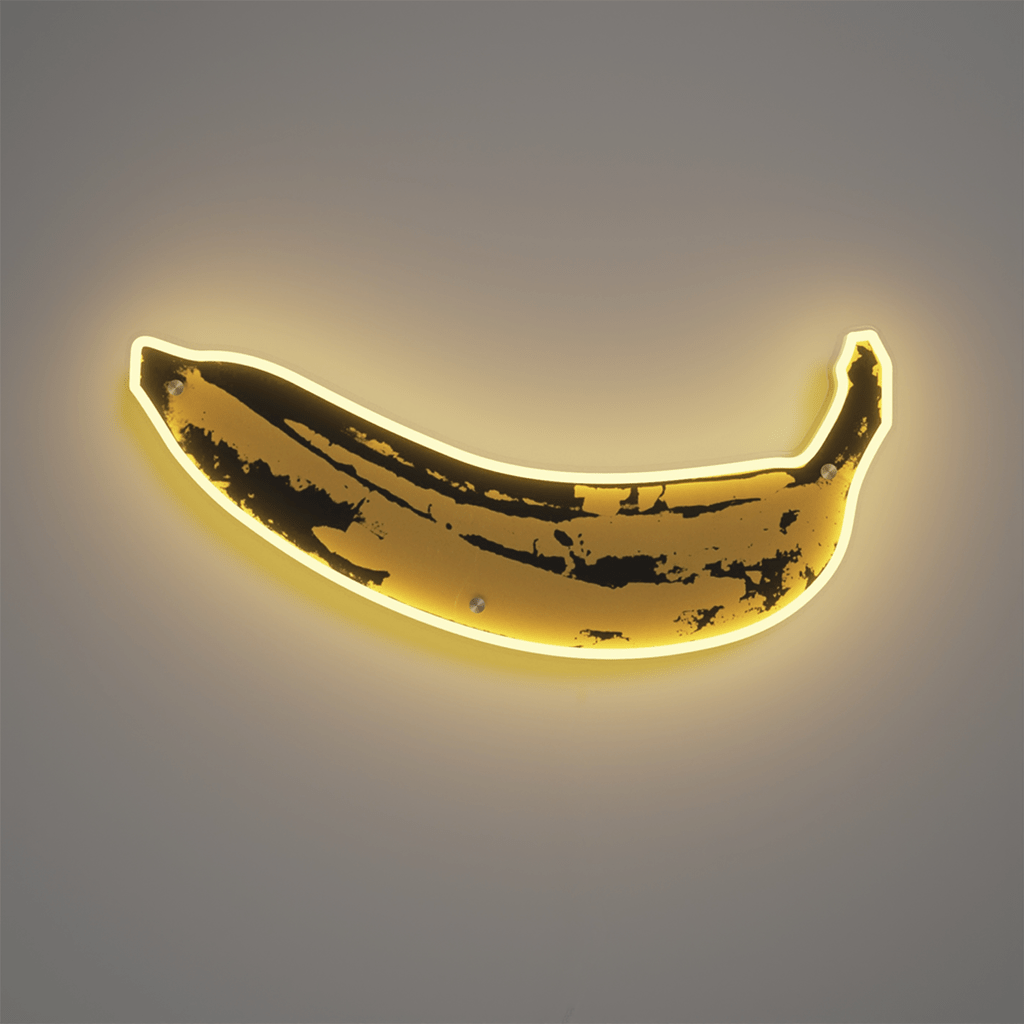 A neon sign of a banana, with a dark background. - Banana