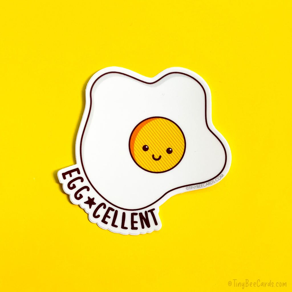 A sticker of a smiling sunny side up egg with the words 