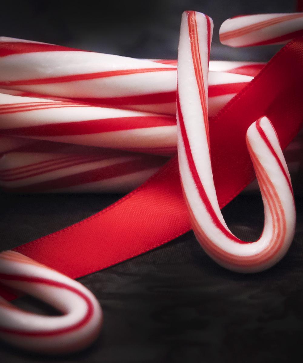 Candy canes on top of red ribbon - Candy cane
