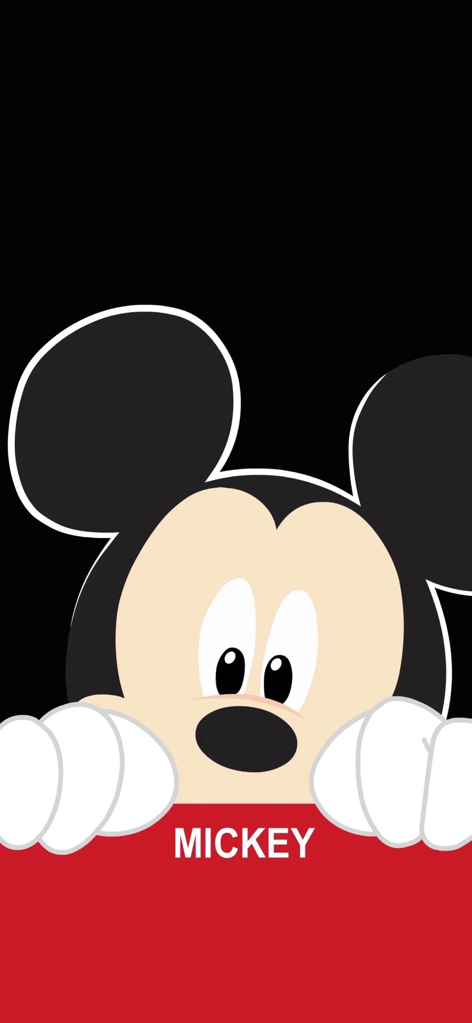 Mickey mouse with his hands over a red background - Mickey Mouse