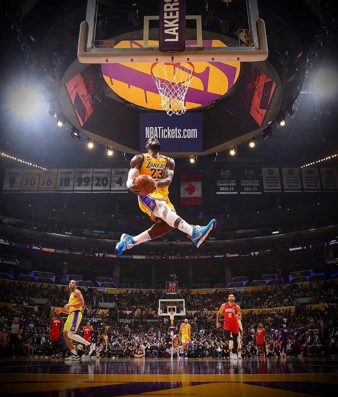LeBron James is in the air with the ball in his hands. - Lebron James