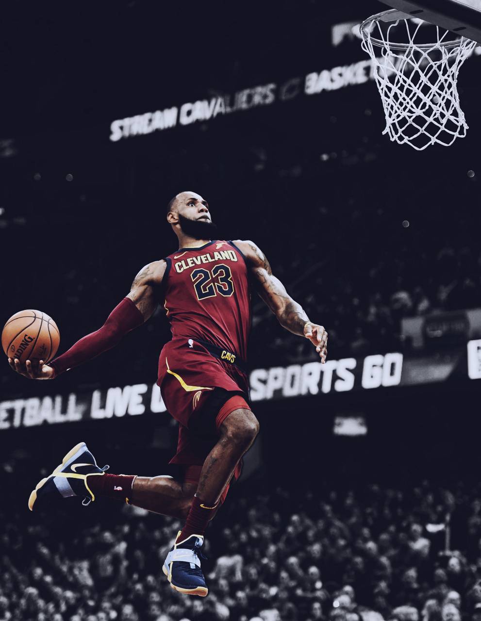 A basketball player jumping in the air with a ball in his hand. - Lebron James