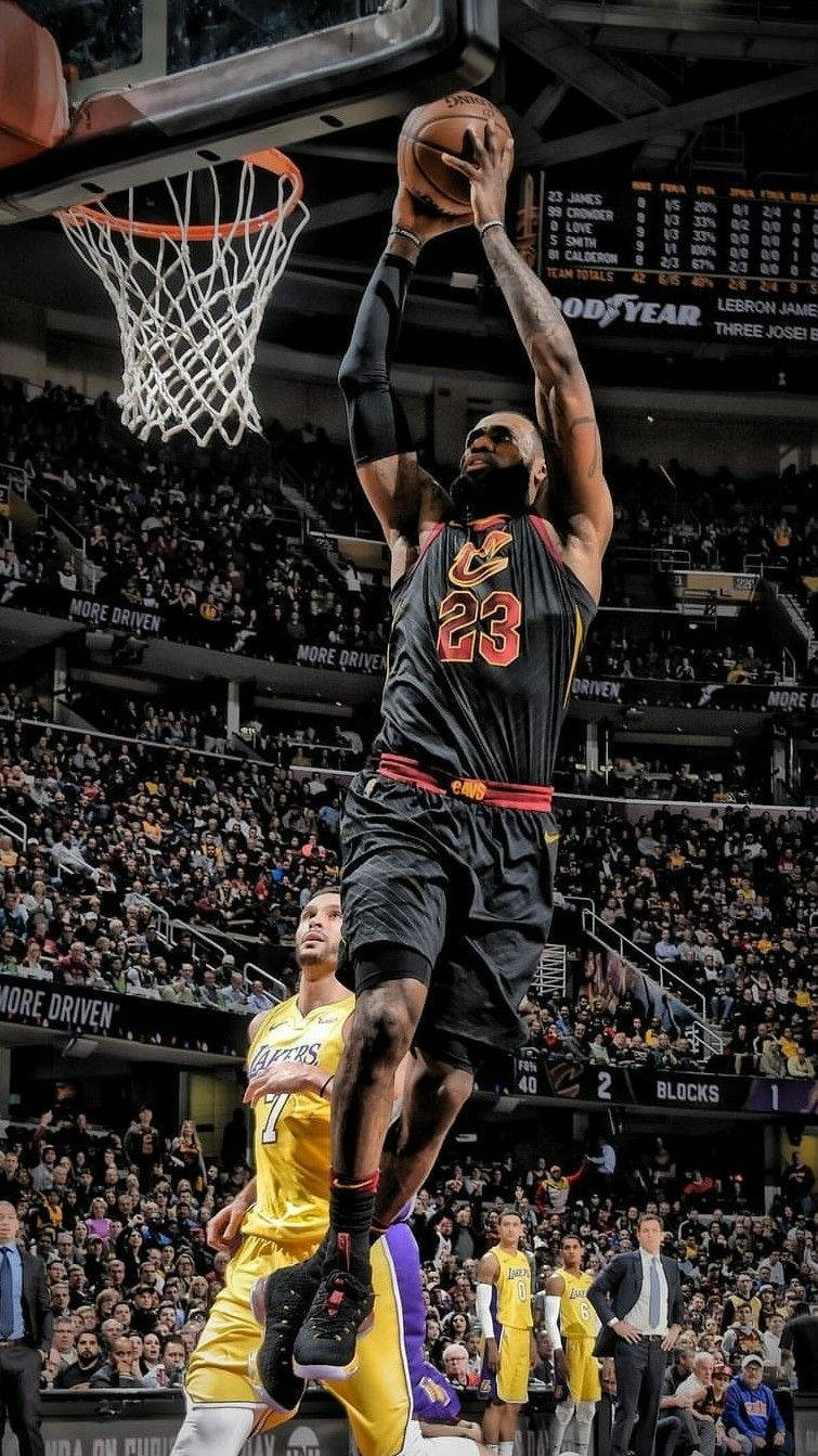 Download Lebron James in his Cavs Jersey Slam Dunking Wallpaper