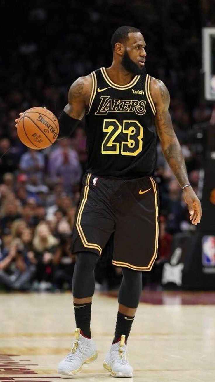 Lebron James wearing a black jersey with the number 23 on it - Lebron James