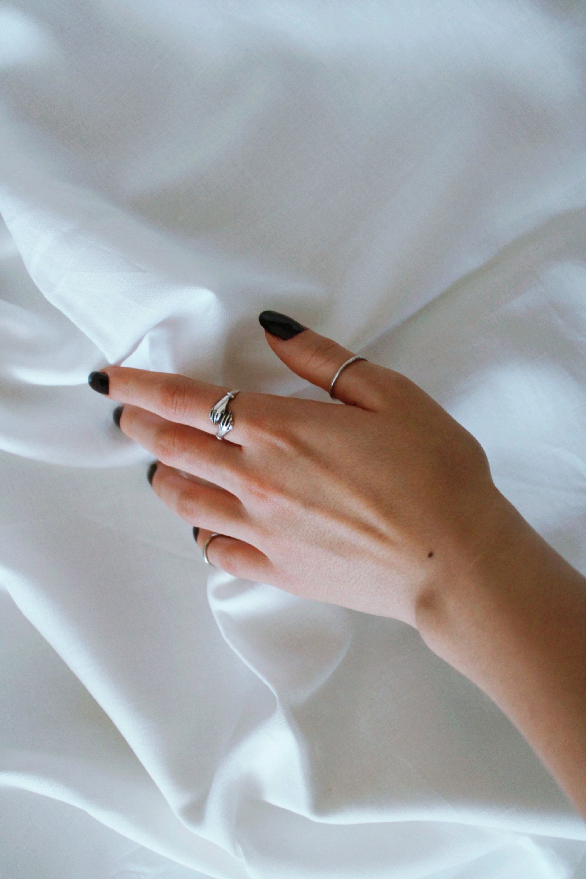 A woman is touching her ring finger - Nails